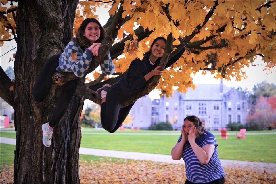PRIMES leaders Ashlyn and Evangeline tackle the climbing tree while faculty advisor Judy Price looks on